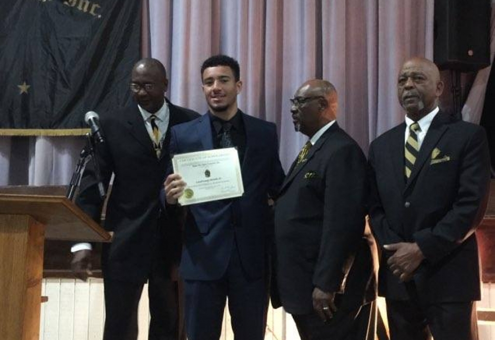 Scholarship recipient Larnell Mitchell flanked by Brothers Elias, Ferguson, and Singleton